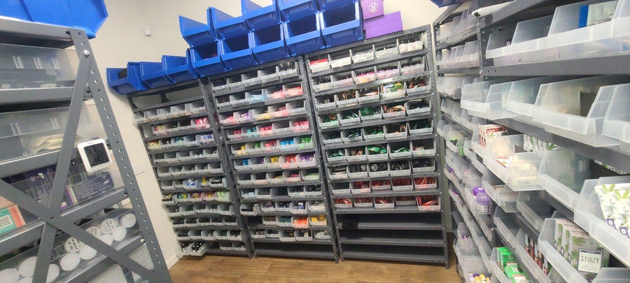 A wider view of clear-bin steel shelving in the stockroom.