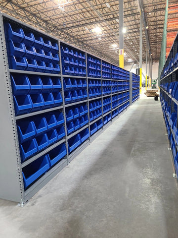 Stackable Bins on Warehouse Shelving Units in Aisles