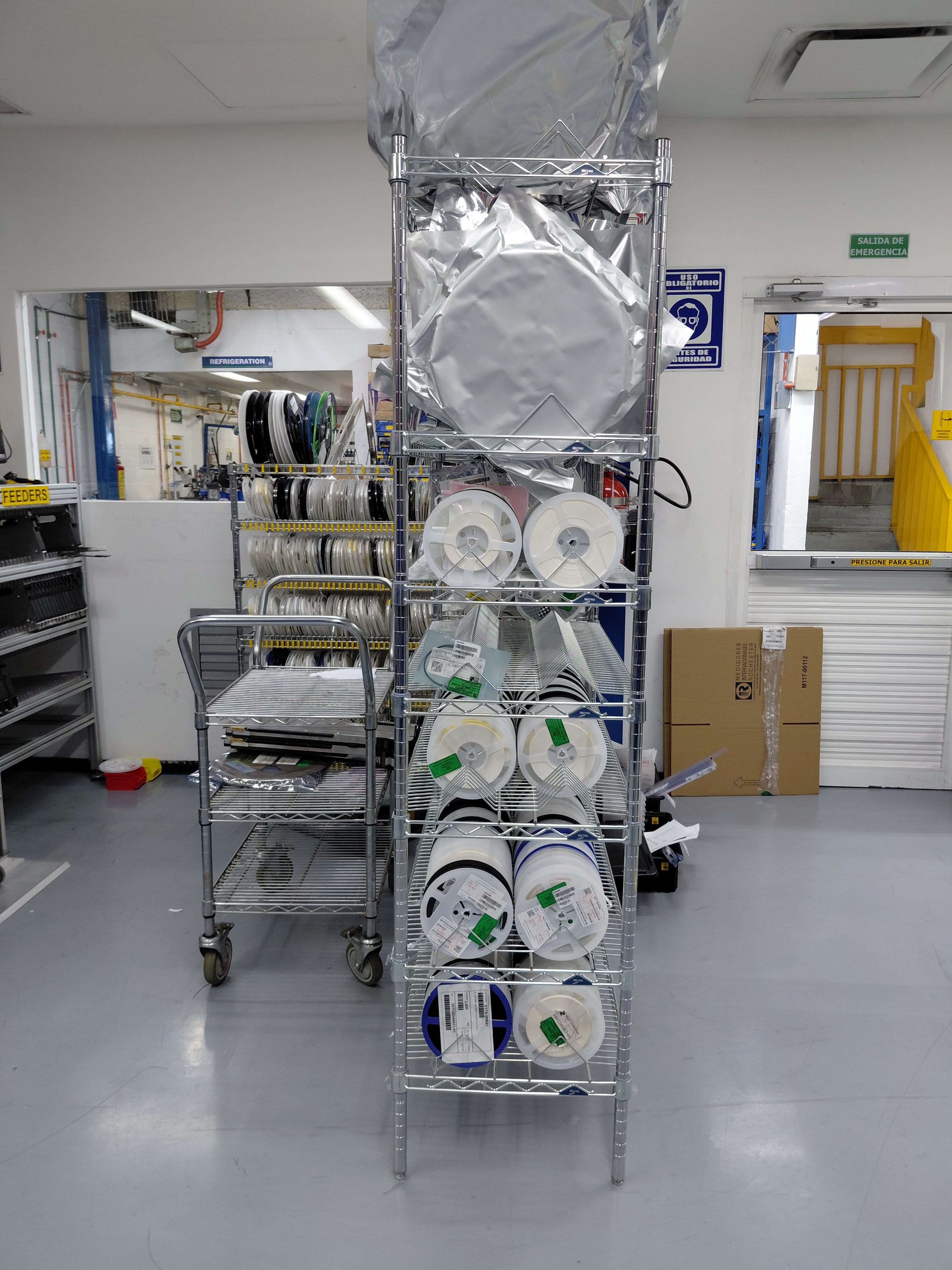 Storage rack with labeled reels in a laboratory setting