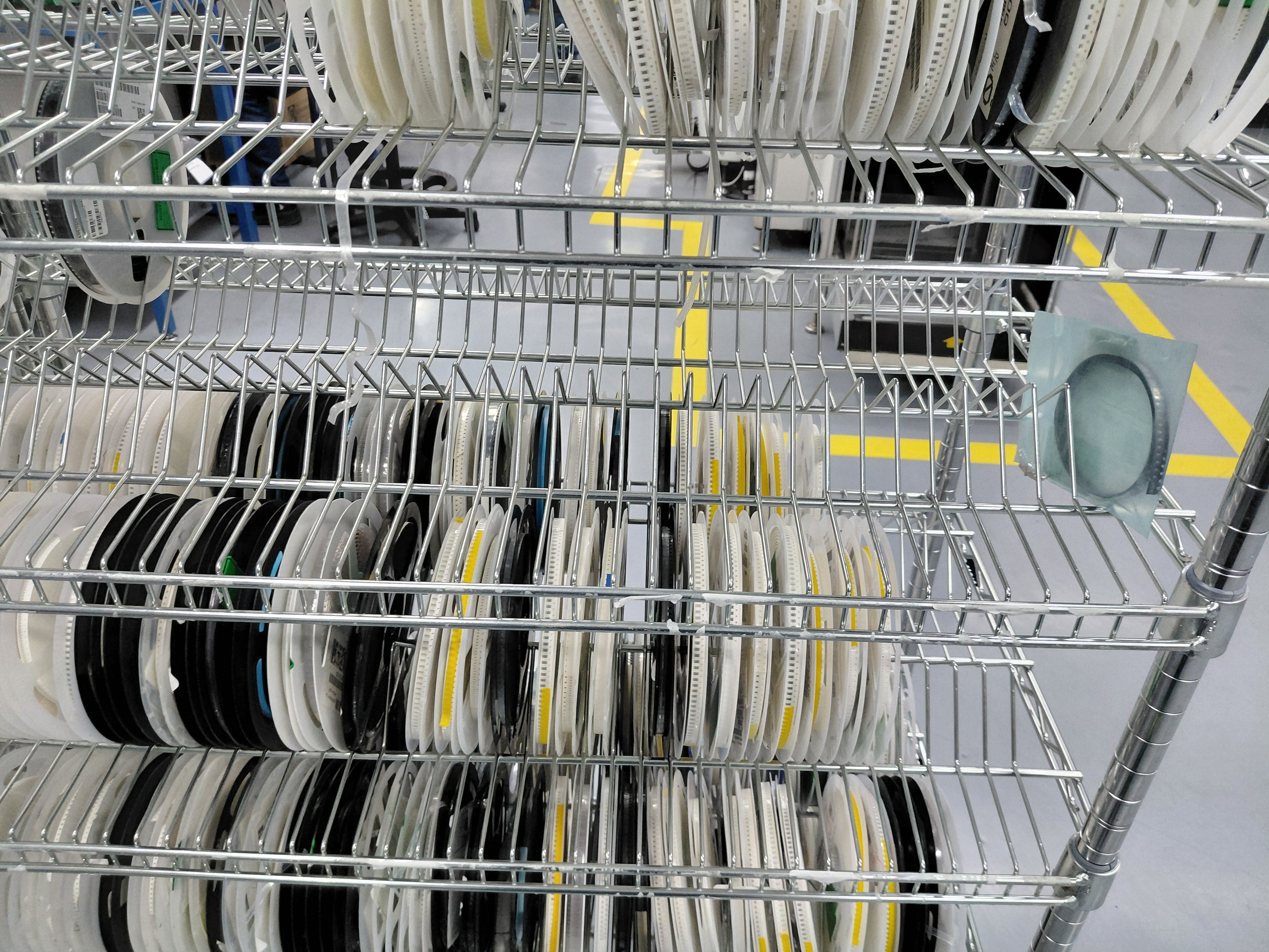 Metal reel storage rack with various reels of tape.
