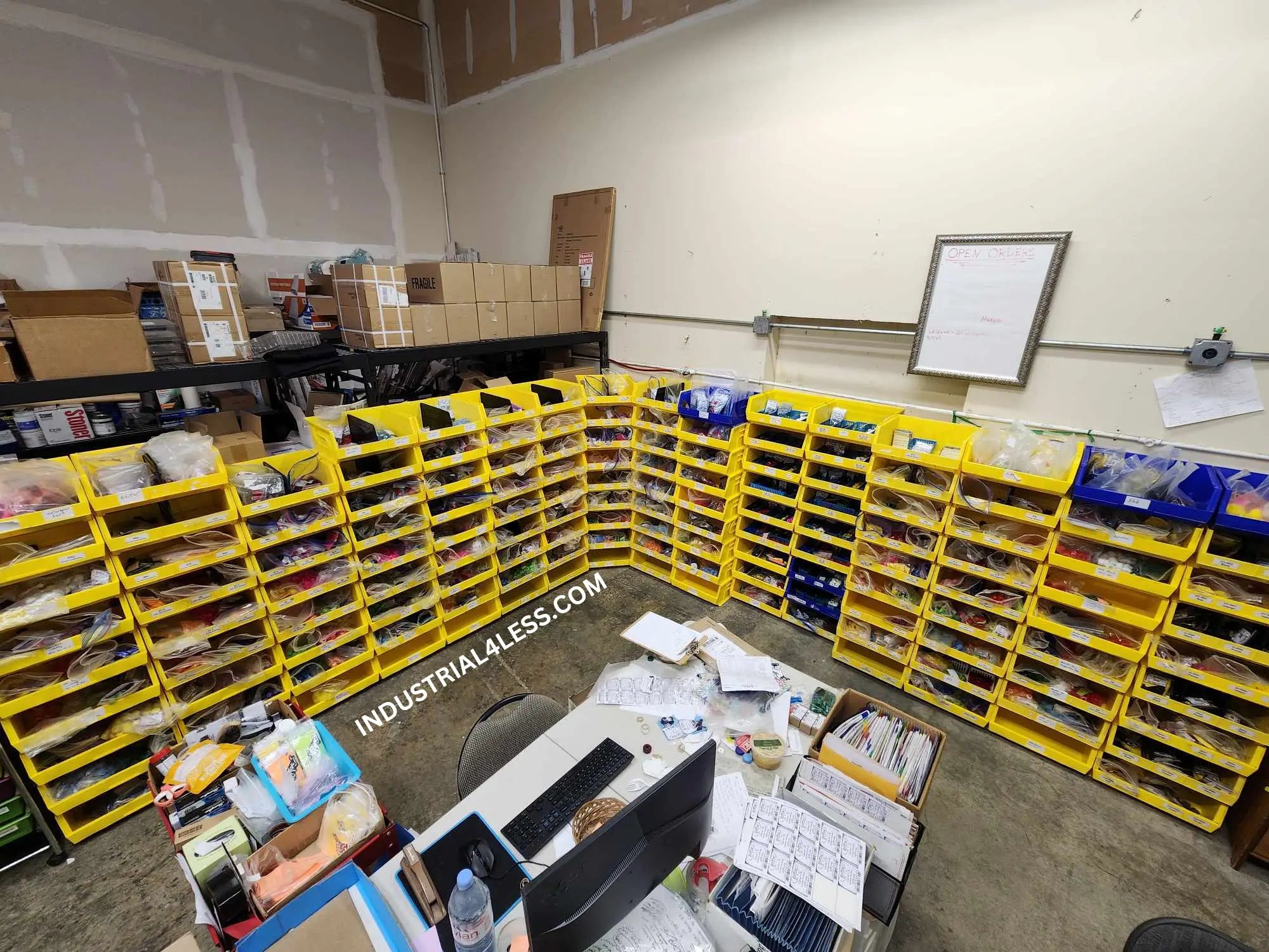 Stackable bin storage system used for organizing small parts and inventory in a warehouse packing and order fulfillment area
