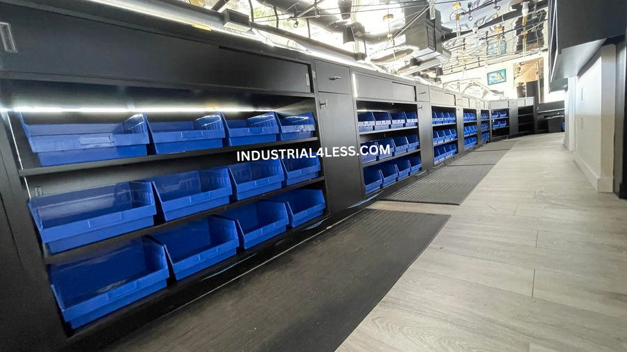 Bulk storage bins along a dispensary stockroom aisle.