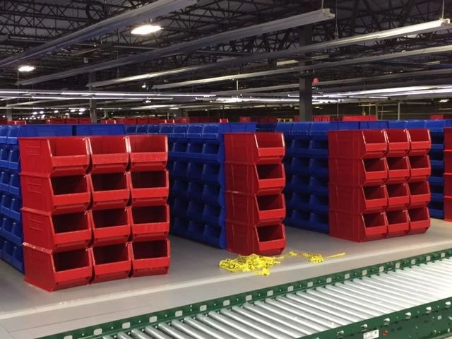Stackable Warehouse Storage Bins Near Conveyor Belt