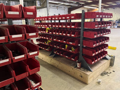 Stackable Bins Hanging in Warehouse