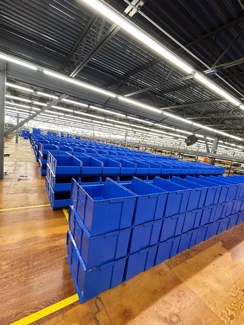 Extra Large Storage Bins Stacked In Warehouse Aisles